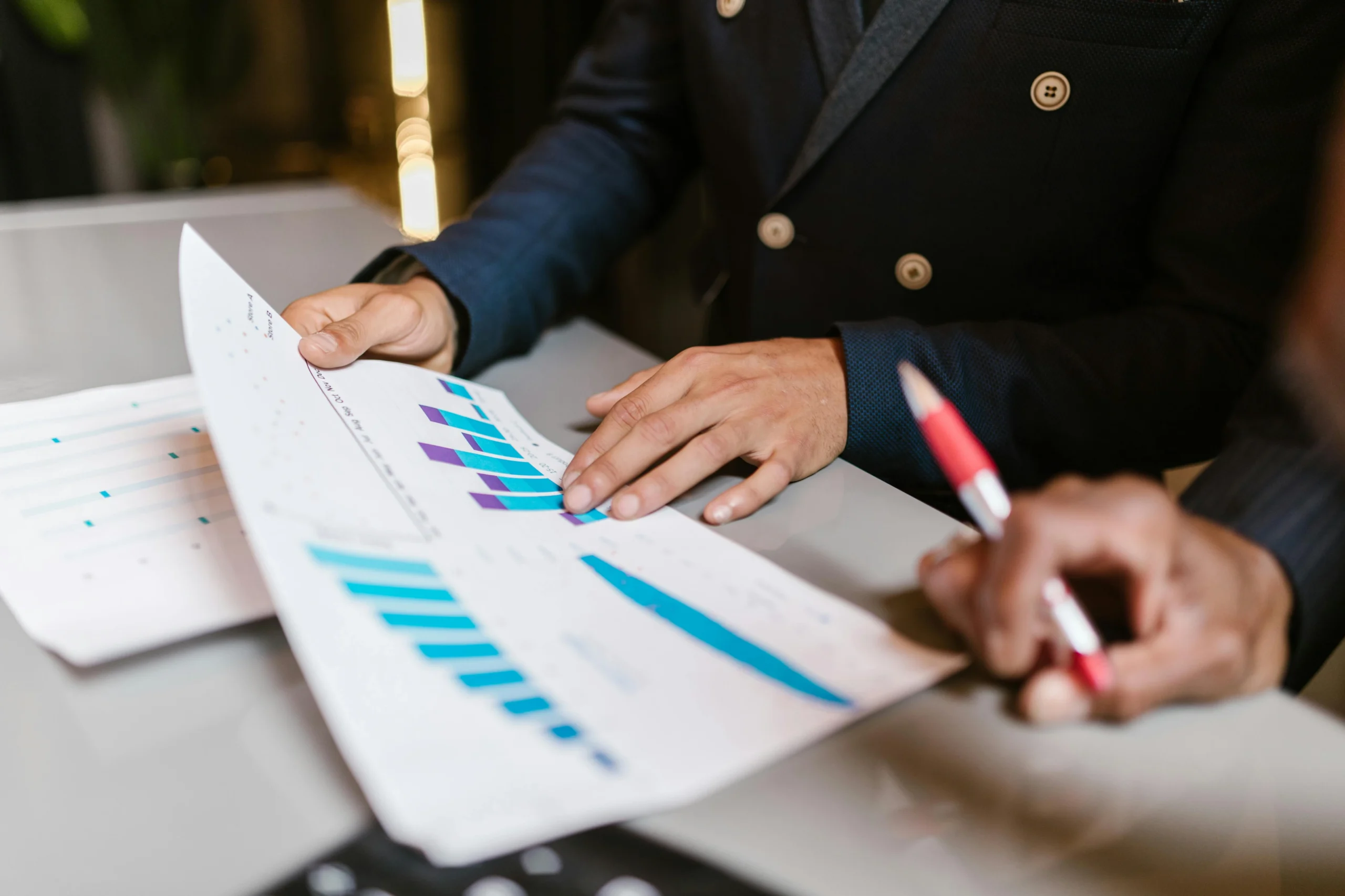 two people reviewing marketing charts