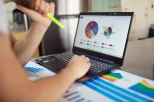 A person looking at metrics on a laptop